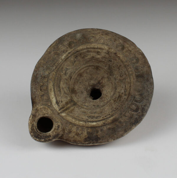 Roman oil lamp with two dogs alternating with two hares in a circle