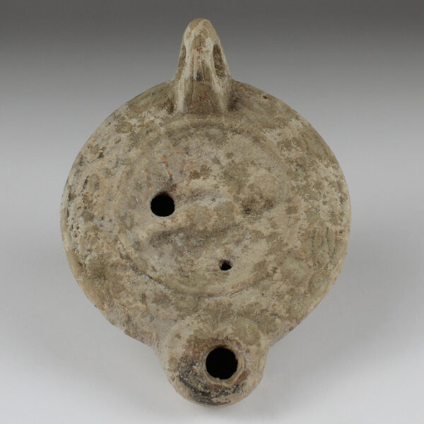 Roman oil lamp with winged genie