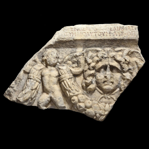 Roman fragment of sarcophagus depicting a Gorgon and Eros with libertus Marcus Aurelius epitaph