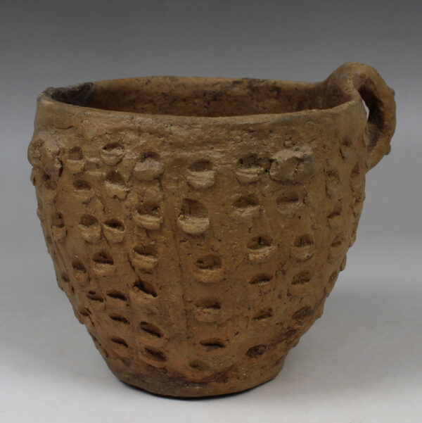 Bronze Age single handled beaker with knob decoration