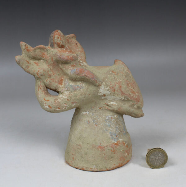 Greek figurine of a little Eros riding on a dolphin, holding a lyre
