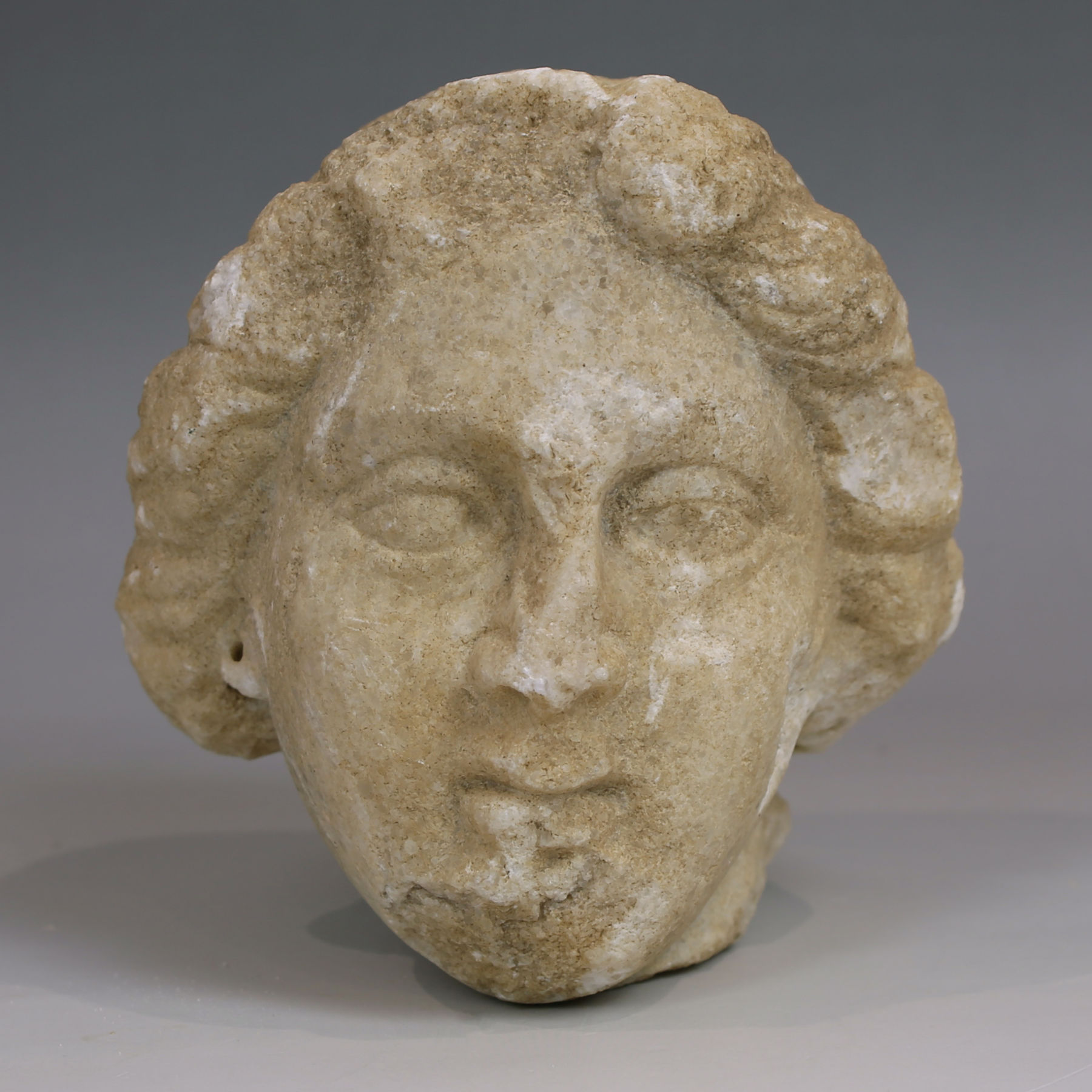 Late Hellenistic / Early Roman head of a woman with tainia Late Hellenistic / Early Roman head of a woman with tainia