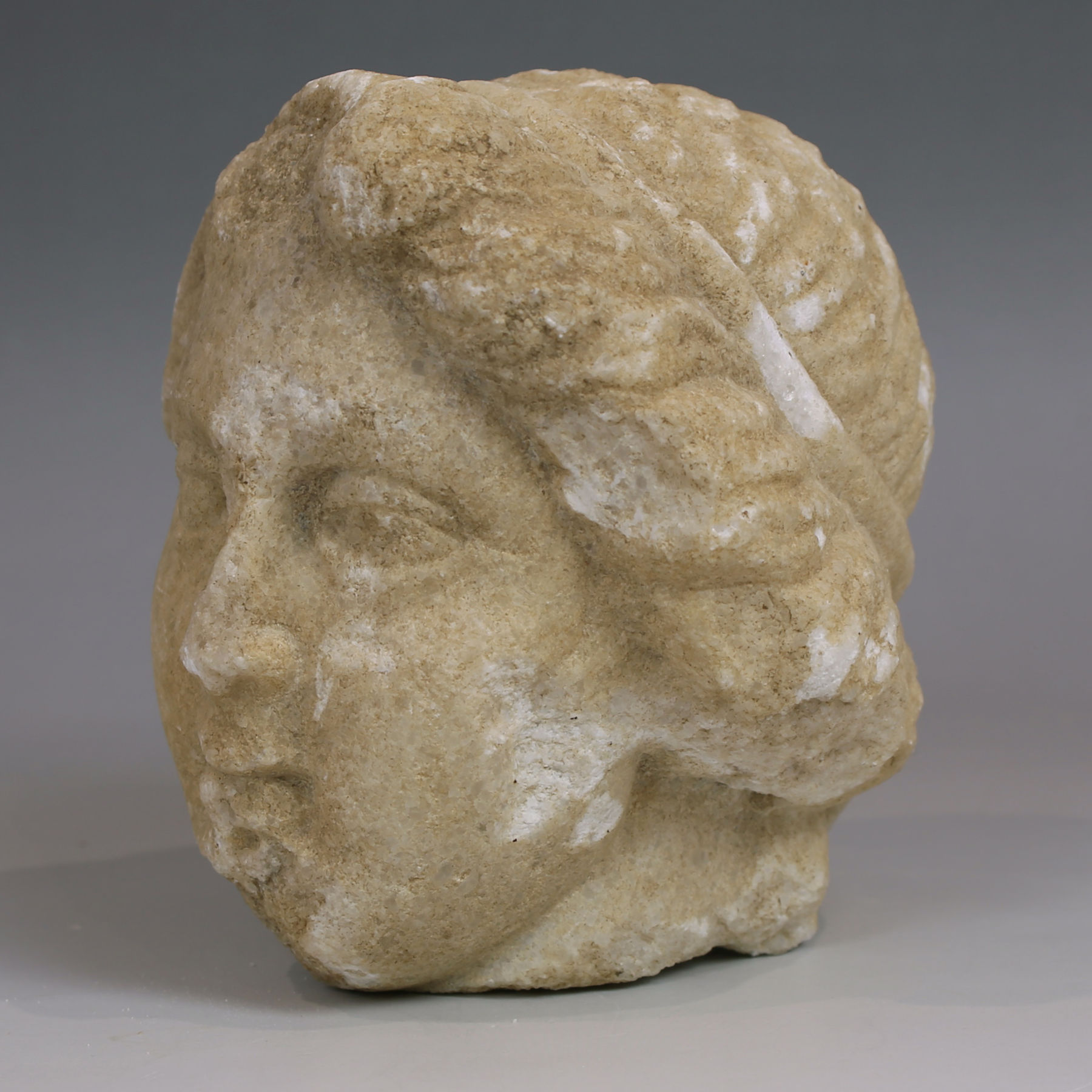Late Hellenistic / Early Roman head of a woman with tainia Late Hellenistic / Early Roman head of a woman with tainia