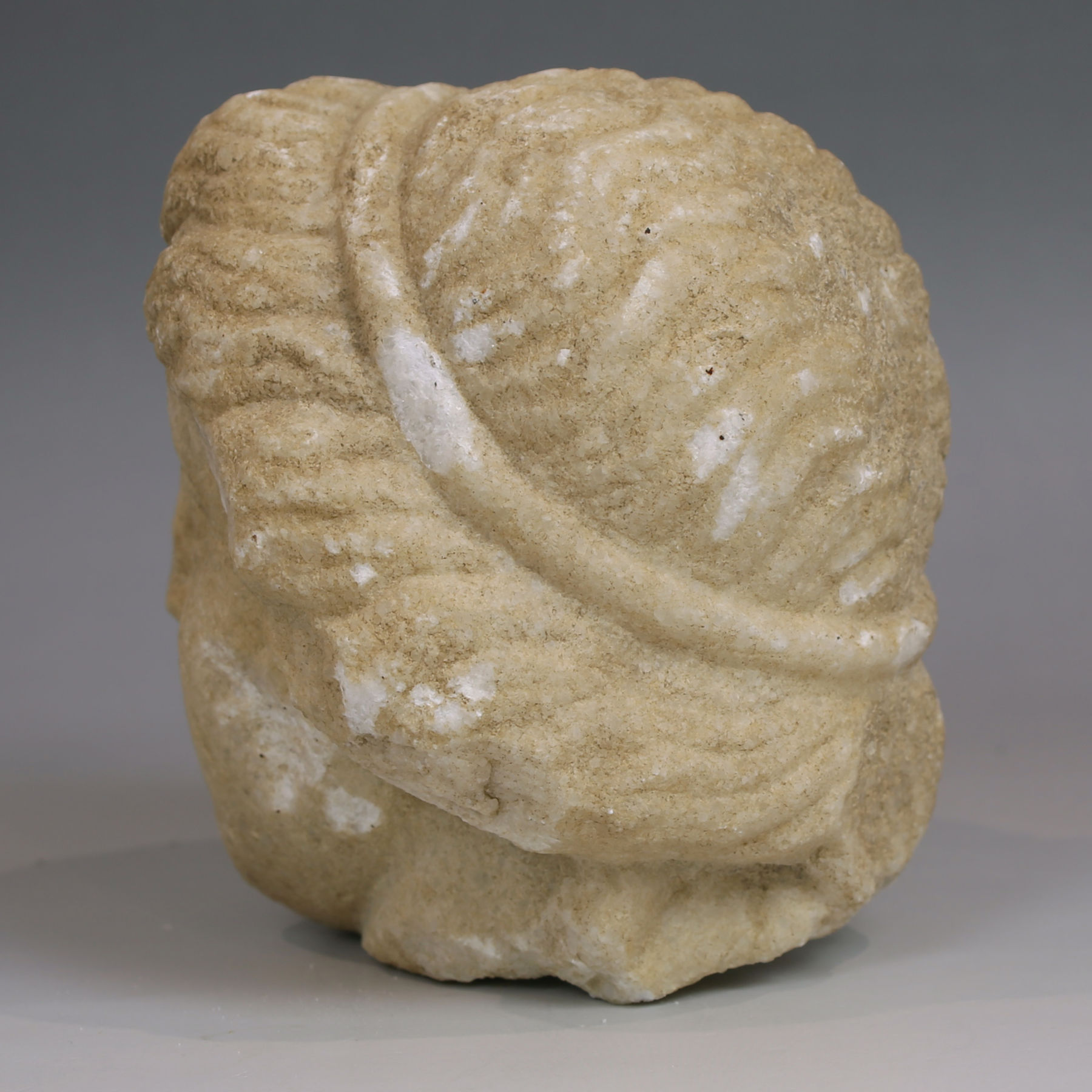 Late Hellenistic / Early Roman head of a woman with tainia Late Hellenistic / Early Roman head of a woman with tainia