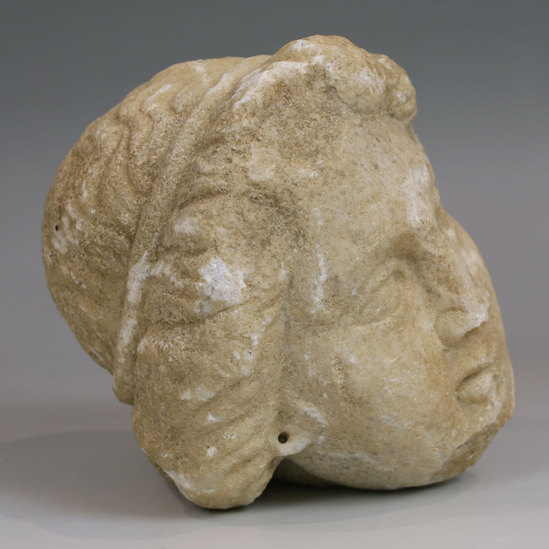 Late Hellenistic / Early Roman head of a woman with tainia Late Hellenistic / Early Roman head of a woman with tainia
